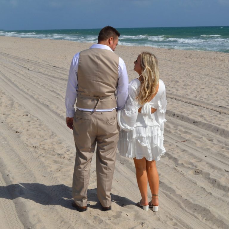 Bride & groom together, with groom giving a kiss on the cheek to his bride in Miami Florida