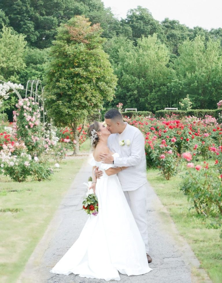 A bride and groom at rose garden in Miami. Wedding by Iris Ramil