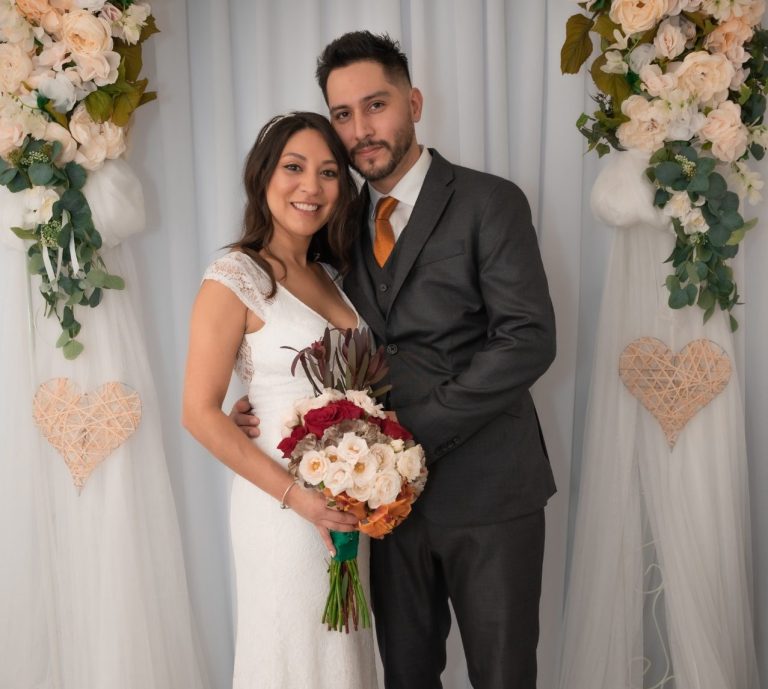 Bride & Groom smiling at Iris Ramil Photographer Bride & Groom standing together on a pathway in Key Largo, Florida