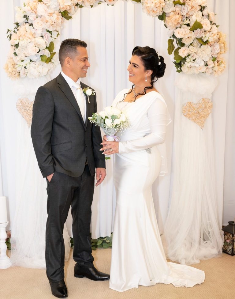 Bride & Groom in front of Wedding Arch at designed by Iris Ramil from Wedding Day Romance Ceremony Suite