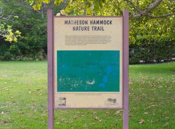Sign for the Macadeon Hammock Nature Trail featuring text and a green graphic.