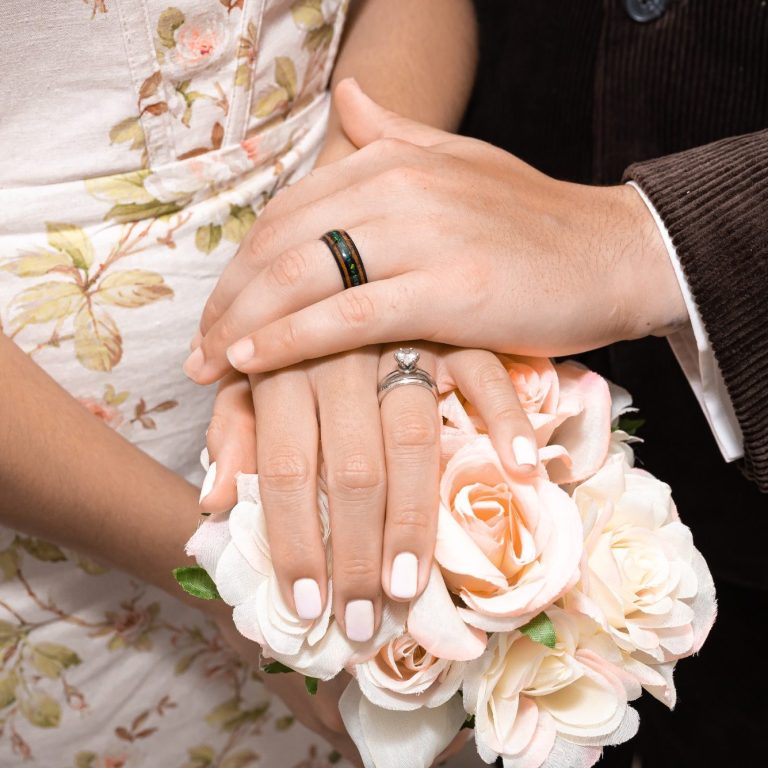 Newlyweds showing off their wedding rings